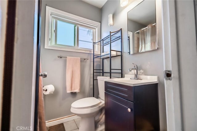 bathroom with vanity, tile patterned floors, and toilet