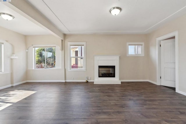 unfurnished living room with dark hardwood / wood-style floors