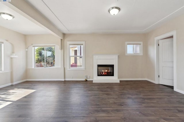 unfurnished living room with dark wood-type flooring