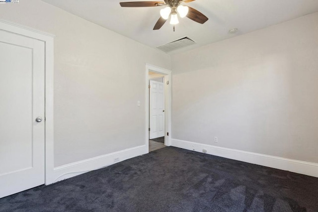 empty room with dark colored carpet and ceiling fan