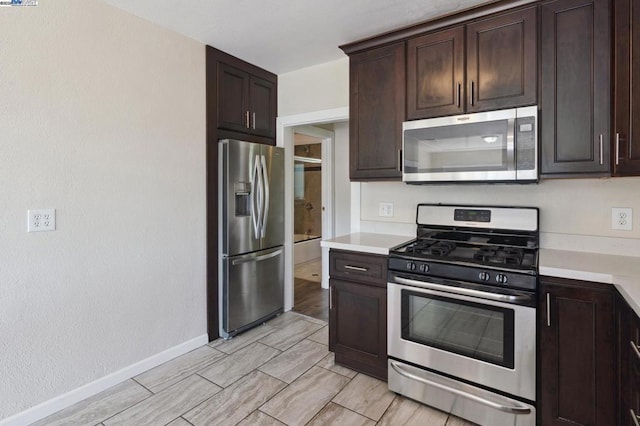 kitchen featuring stainless steel appliances and dark brown cabinetry