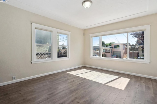 unfurnished room featuring dark hardwood / wood-style flooring