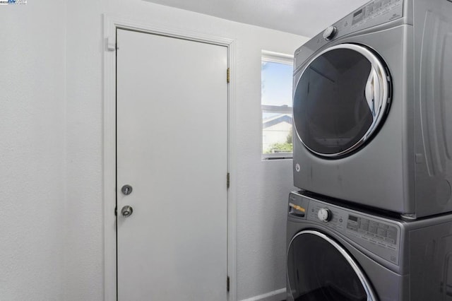 laundry room featuring stacked washer and dryer