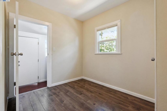 spare room with dark hardwood / wood-style floors