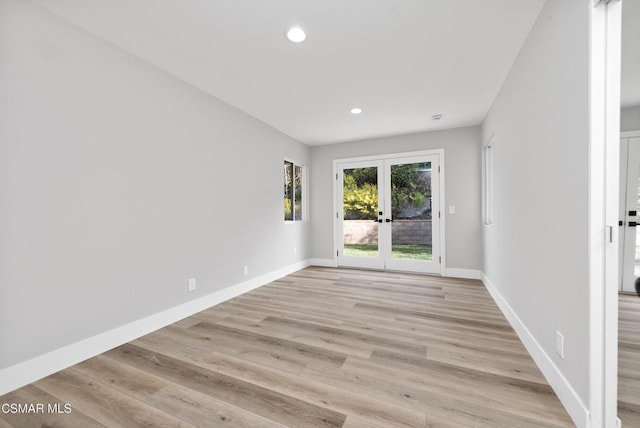 unfurnished room featuring light wood-type flooring and french doors