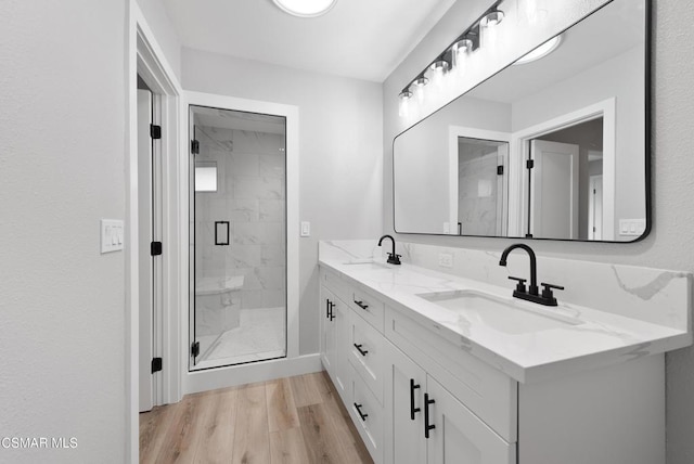 bathroom with vanity, hardwood / wood-style floors, and an enclosed shower