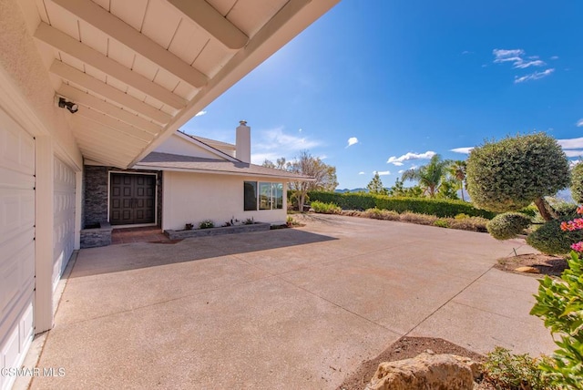 view of patio featuring a garage