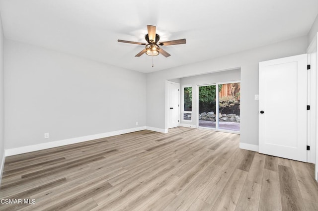 spare room with ceiling fan and light wood-type flooring