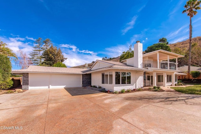 view of front of property with a garage and a balcony