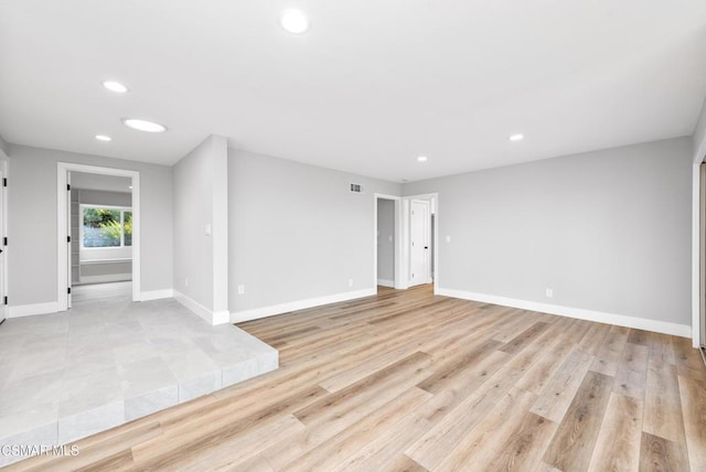 unfurnished room with light wood-type flooring