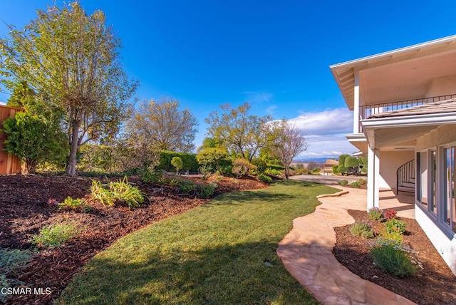 view of yard featuring a balcony