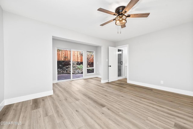 empty room with ceiling fan and light hardwood / wood-style floors