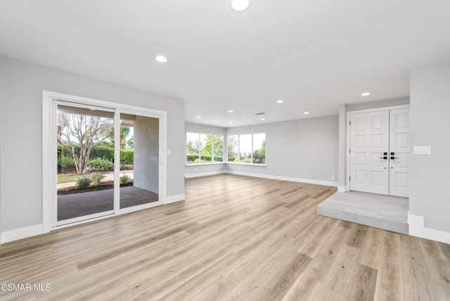 unfurnished living room with light hardwood / wood-style flooring