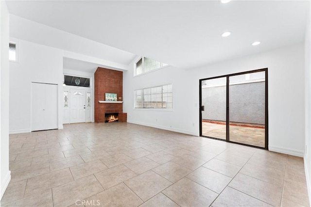 unfurnished living room with recessed lighting, a large fireplace, baseboards, and light tile patterned floors