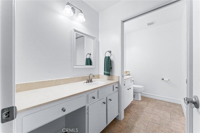 bathroom with vanity and toilet