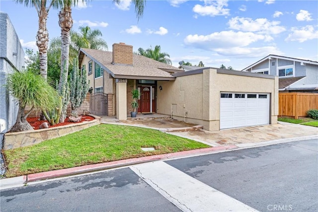 view of front of property with a garage and a front yard