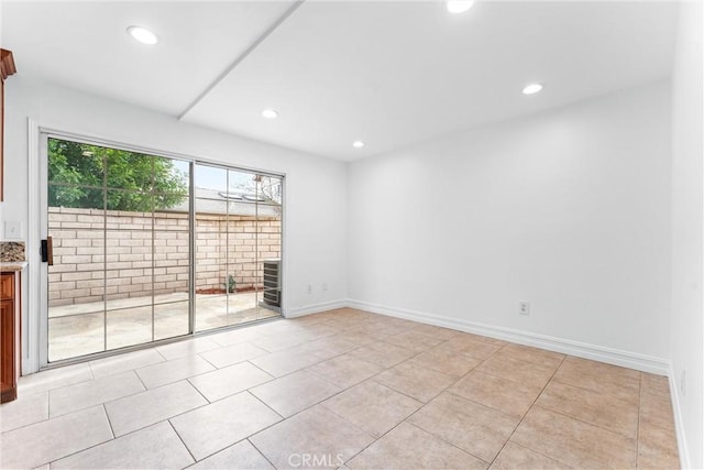 empty room with baseboards and recessed lighting