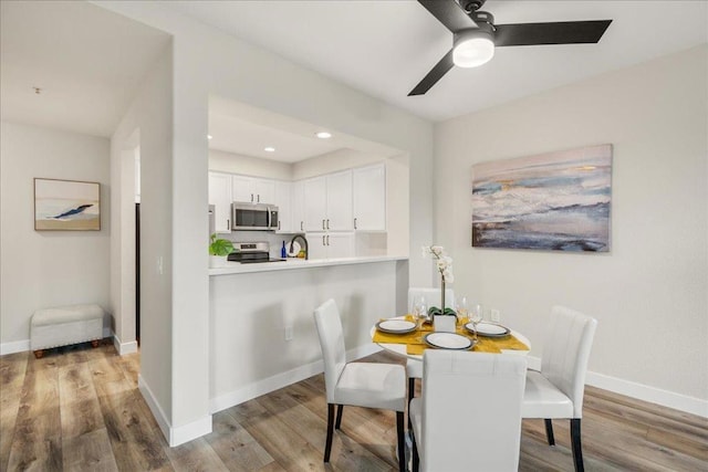 dining room featuring hardwood / wood-style flooring and ceiling fan