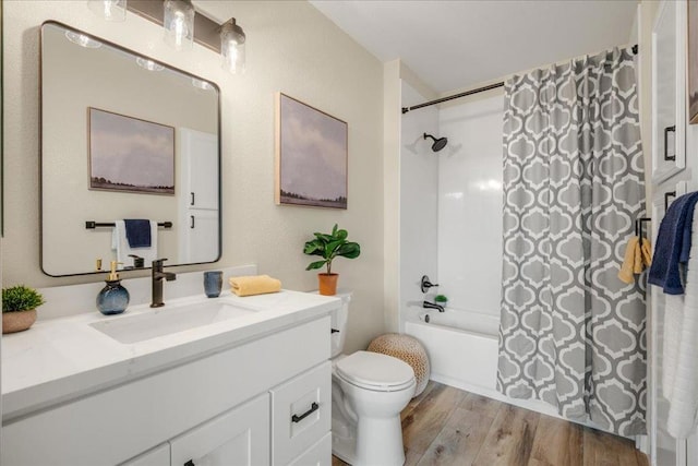 full bathroom featuring vanity, toilet, hardwood / wood-style floors, and shower / bath combo