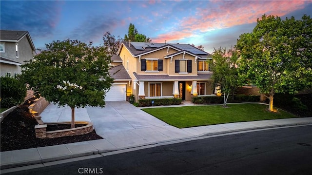 craftsman-style house featuring a garage, a lawn, and solar panels