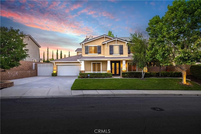 view of front of house with a yard and a garage