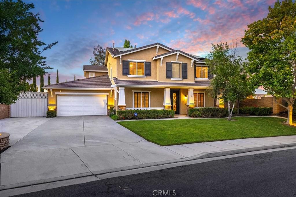 craftsman-style home with a garage and a yard