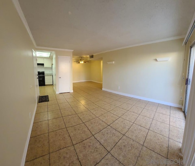 tiled empty room featuring crown molding and ceiling fan