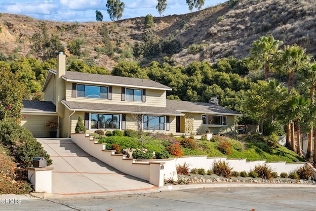 view of front facade with a garage and a mountain view