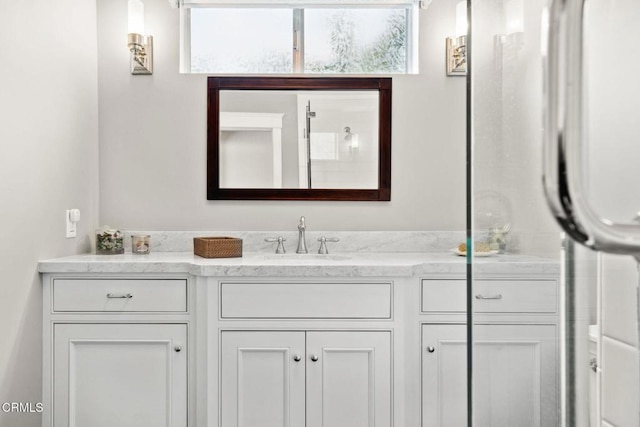 bathroom featuring vanity and an enclosed shower