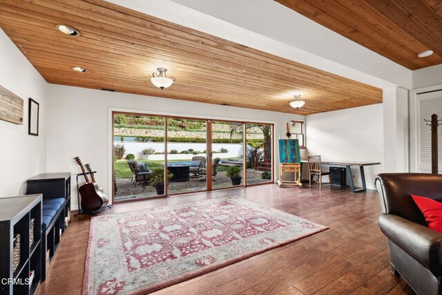 living room featuring wood ceiling and dark hardwood / wood-style flooring