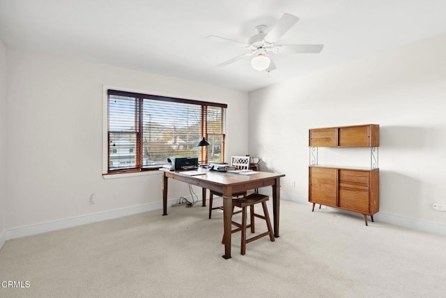 office space with ceiling fan and light colored carpet