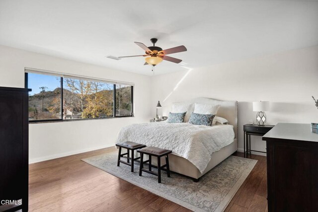 bedroom featuring ceiling fan and dark hardwood / wood-style flooring