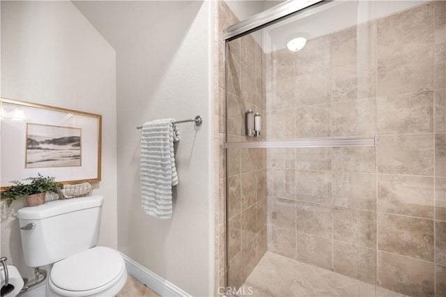 bathroom with toilet and an enclosed shower