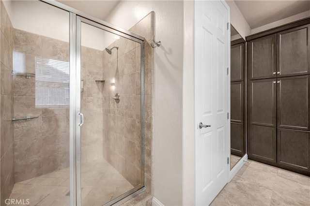 bathroom featuring a shower with shower door