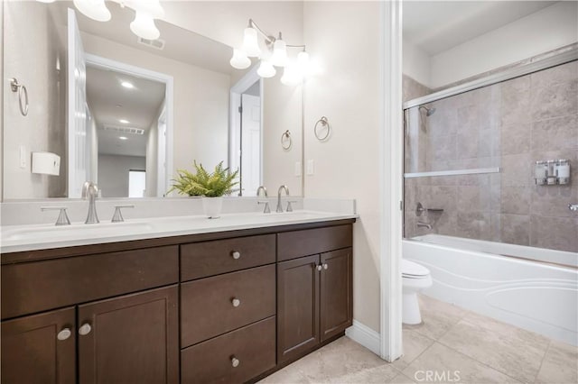 full bathroom with vanity, tiled shower / bath combo, and toilet