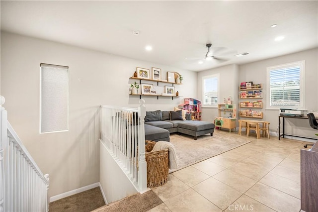 living room featuring light tile patterned floors, a wealth of natural light, and ceiling fan