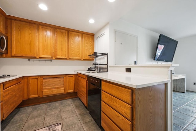 kitchen with kitchen peninsula, sink, and black appliances