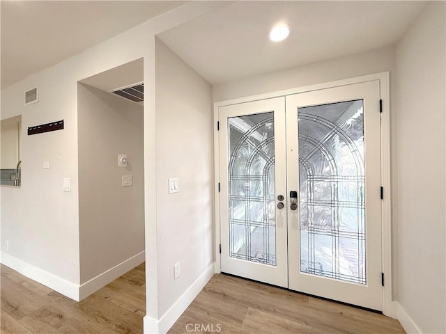 doorway featuring light hardwood / wood-style floors and french doors