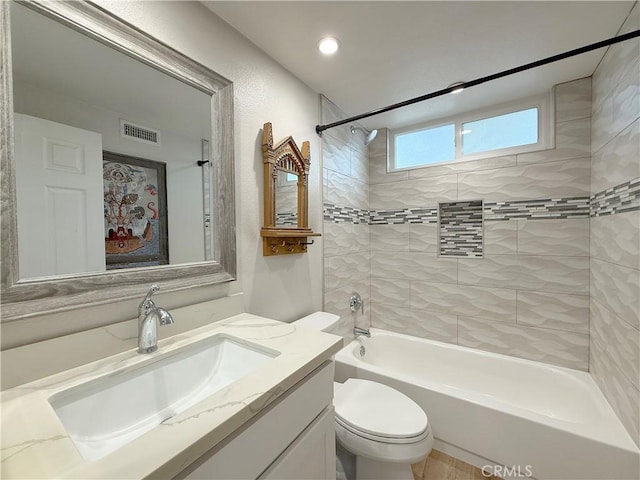 bathroom featuring toilet, vanity, shower / tub combination, and visible vents