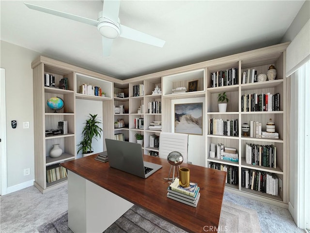 office area with carpet floors, baseboards, and a ceiling fan