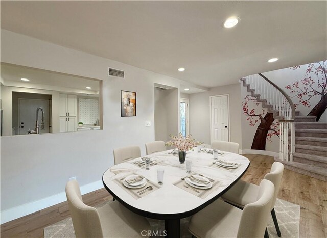 dining room featuring sink and light wood-type flooring