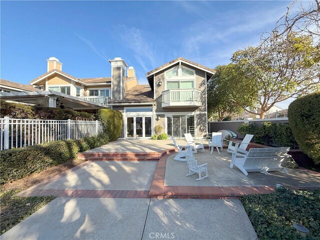 back of property featuring a patio area and a balcony