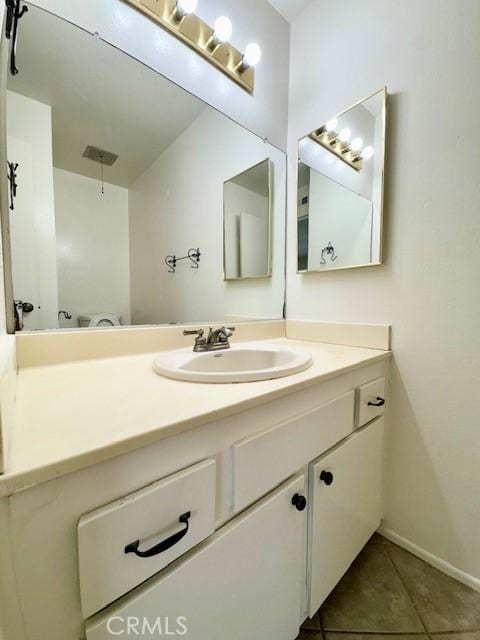 bathroom with tile patterned floors and vanity