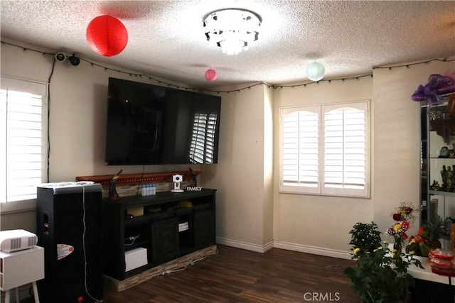 interior space with dark hardwood / wood-style floors and a textured ceiling