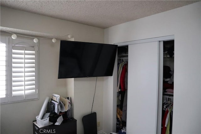 bedroom with a closet and a textured ceiling