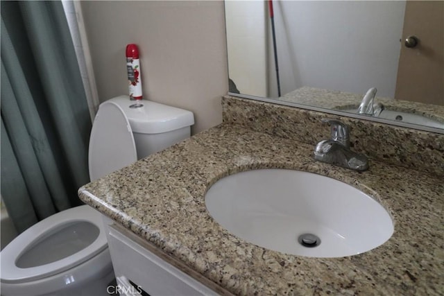 bathroom with vanity and toilet