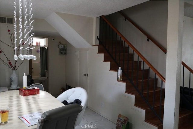 stairs featuring tile patterned floors