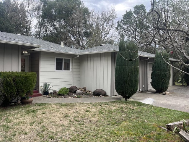 view of side of property with a yard