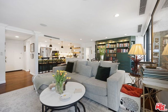 living room with hardwood / wood-style flooring and ornamental molding