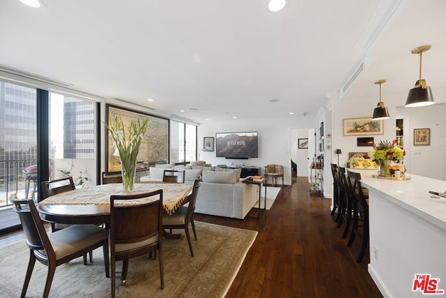 dining space featuring expansive windows, ornamental molding, and dark hardwood / wood-style floors